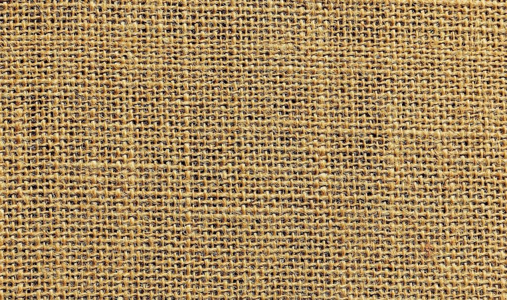 Jute vloerkleed in een woonkamer met natuurlijke textuur en warme aardse kleuren voor een rustieke, duurzame inrichting